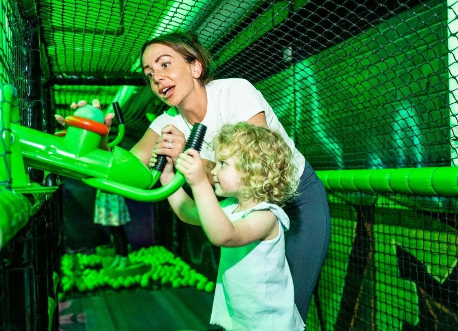 Child being helped by parent on Ballistics Shooting Gallery