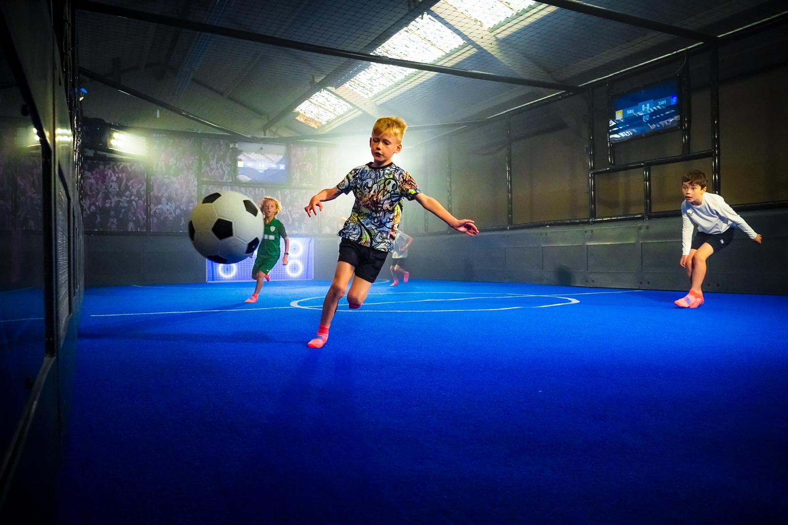 children playing football on interactive court